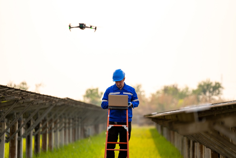 Drone operator conducting an inspection of solar panels, ensuring efficient energy use.