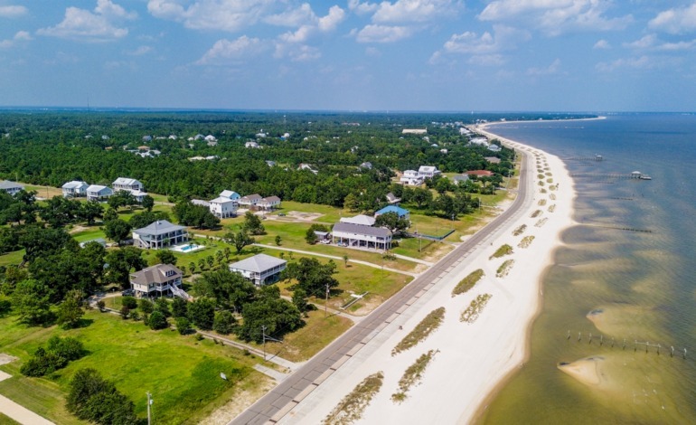 A serene aerial view of the beach in Waveland, MS—showcasing why video tours can make your listings sell faster by zooming in to highlight just how close the beach is and its inviting charm.